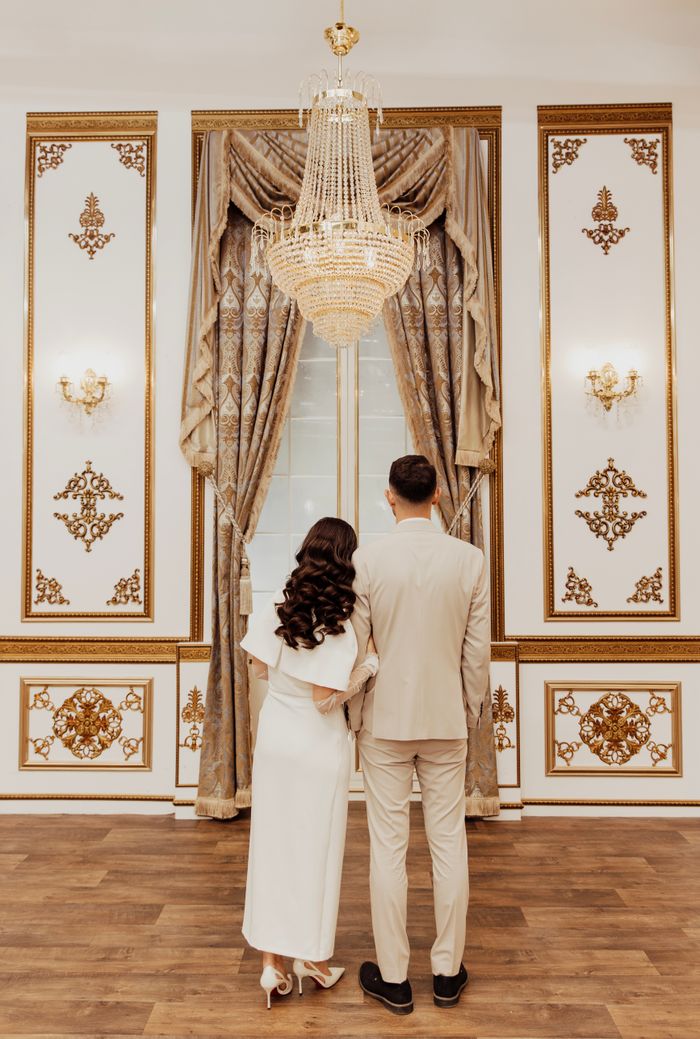 A couple stands elegantly in a luxurious Istanbul venue, perfect for artistic weddings.
